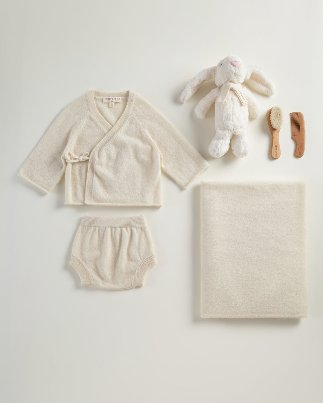 Petit Louli Spring Paris Cashmere Set — lifestyle shot with baby model