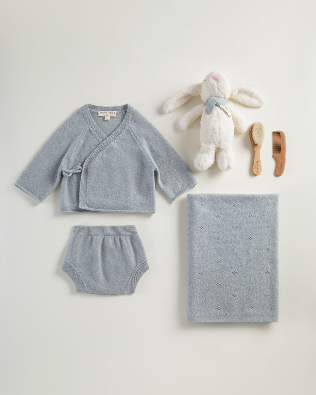 Petit Louli Spring Paris Cashmere Set with Pointelle blanket — lifestyle shot with baby model