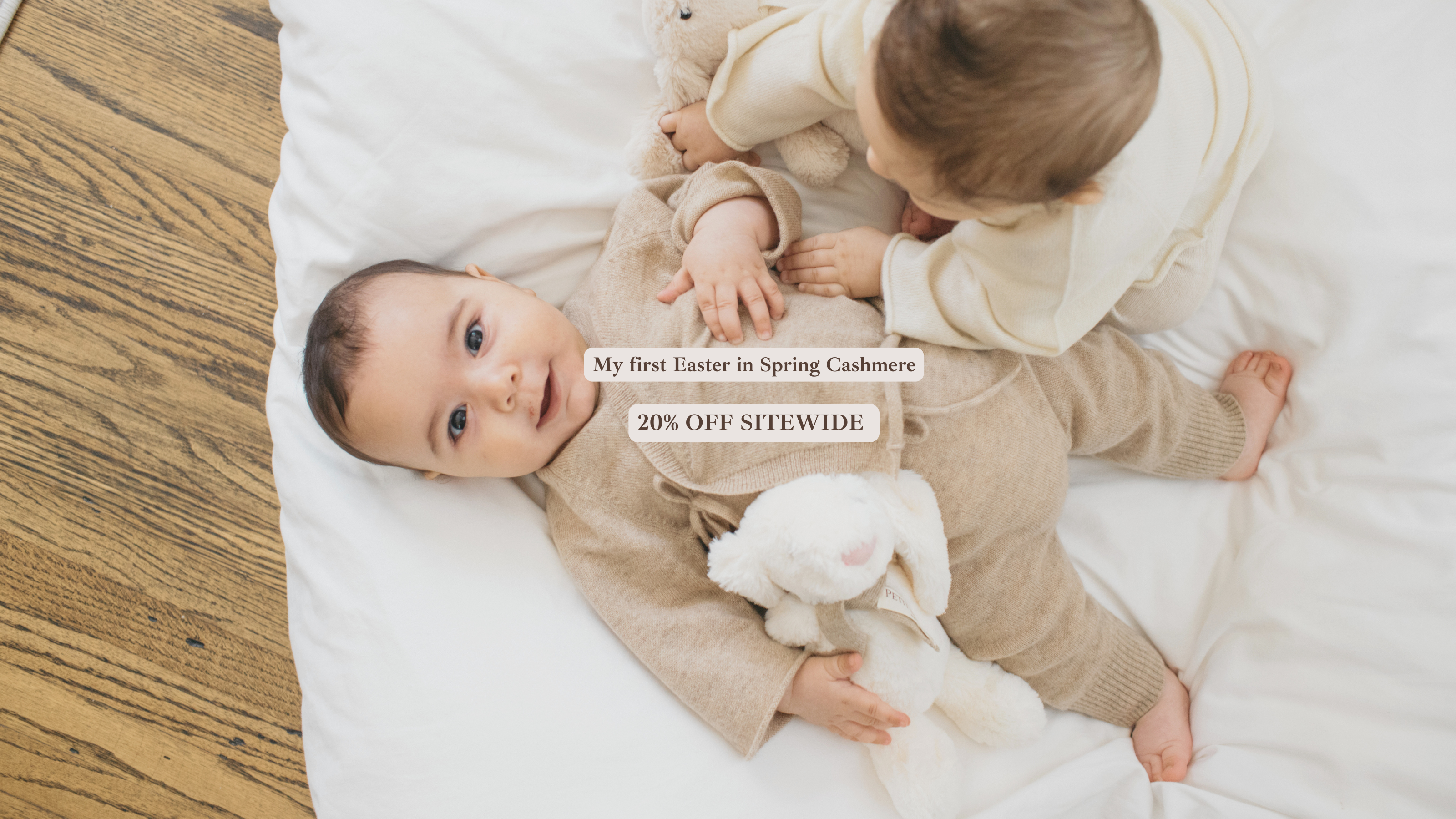 petit louli babies wearing organic cashmere clothing for easter with a bunny